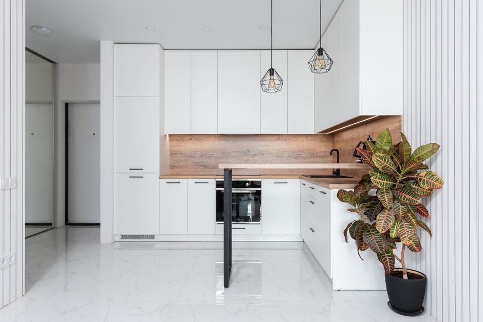Light kitchen with white cabinets and modern appliances